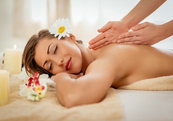 Woman enjoying during a back massage at a spa.