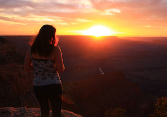 A woman looking in awe at a beautiful sunset