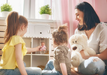 Girls holding lottie dolls