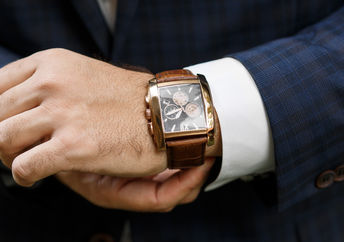 A closeup of designer watch on a businessman's hand