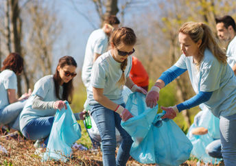 people holding up a sign that says volunteer