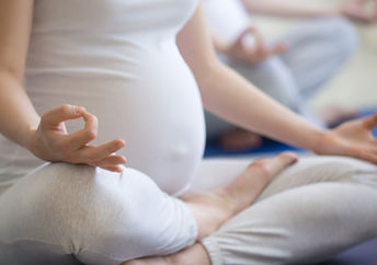 A pregnant woman meditating