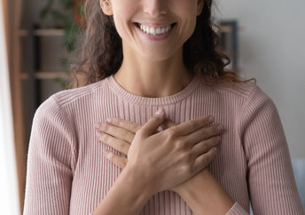 A woman smiles after receiving a compliment.