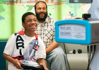 A boy in the hospital plays Nintendo.