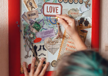 A vision board idea for travel to France is made by a woman who wants to manifest travel.