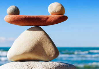 A photograph of stones in balance to convey work life balance