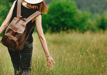 Woman walking outdoors to show intrinsic motivation