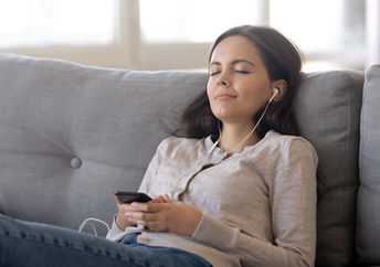 Woman listing to relaxing sleep music.