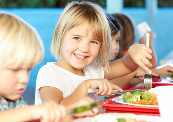 Little girl eating a healthy school lunch