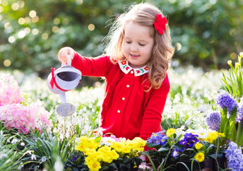 A child in a flower garden.