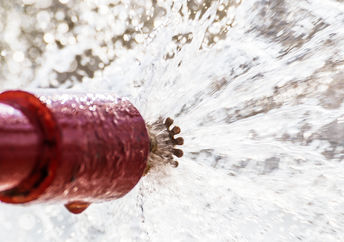 Sprinkler head shooting our fire-suppression materials.