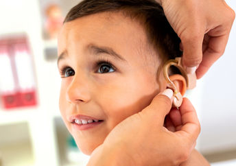 Boy being fitted for a hearing aid.