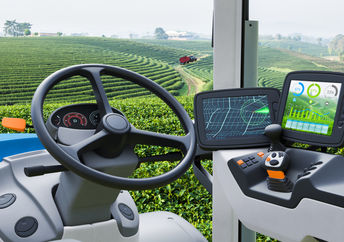 Autonomous tractor working in a green tea field.