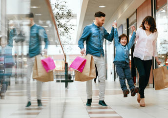 Happy family shopping in mall
