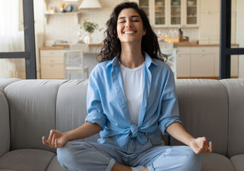 A woman is practicing mindfulness and feeling joyful.