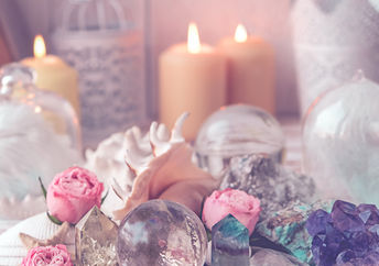 Flickering candles alongside crystals and healing stones are used to manifest dreams.