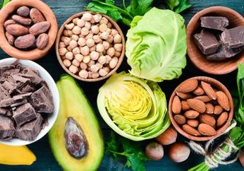 Foods that are rich in magnesium, including dark chocolate, nuts, and avocado.