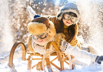Two boys enjoying a winter wonderland.