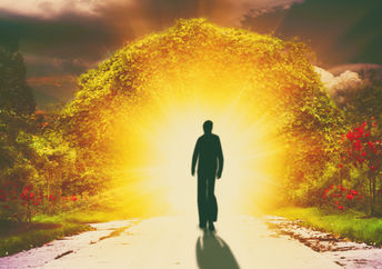 A person walks down a road into light, reflecting the spiritual love a lightworker shines.