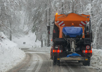 DE-icing truck on a snow-covered road.
