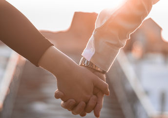 A couple holding hands.