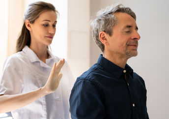 A man receives a healing reiki treatment.