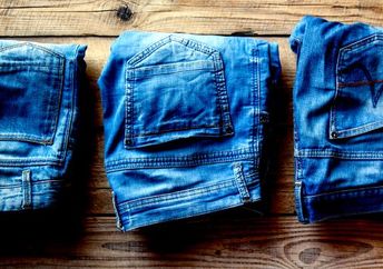 Sustainable blue denim jeans on a wooden board