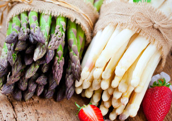 Bunches of fresh green and white asparagus.