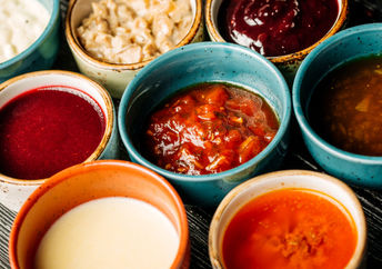 Bowls of various healthy vegan condiments.