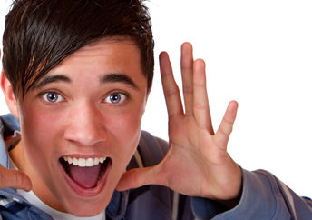 Teen holding his hands by his head and announcing interesting news.