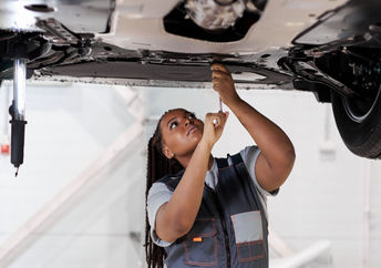 A female car mechanic at work.