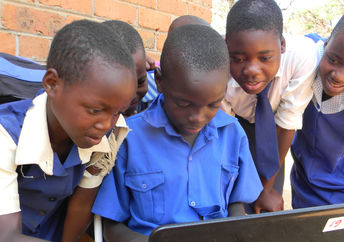African students learning to use a computer.