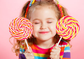 Happy child with candy lollipops.