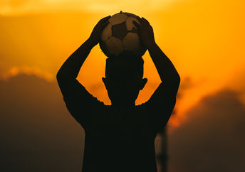 A child holding a soccer ball.