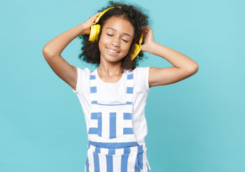 Cute kid enjoying music.