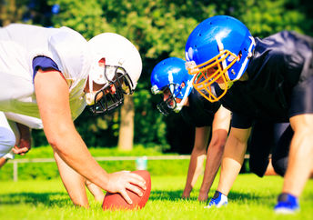 High school football players facing off.