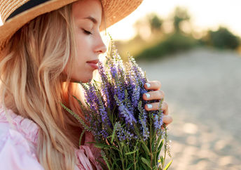 Women smelling fragrant flowers