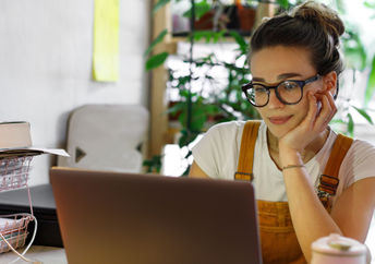 A young woman typing on a computer.