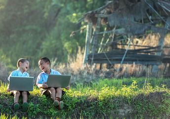 Two boys studying with a laptop.