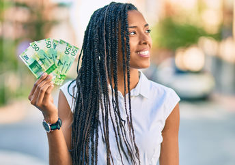 Young woman holding banknotes.