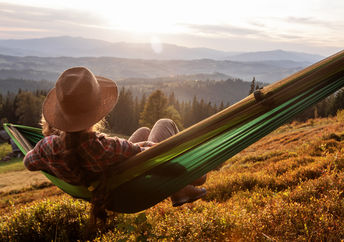 Resting on a hammock.