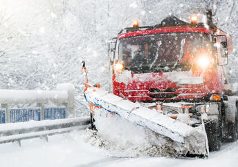 Snowplow clearing highway after a winter storm.