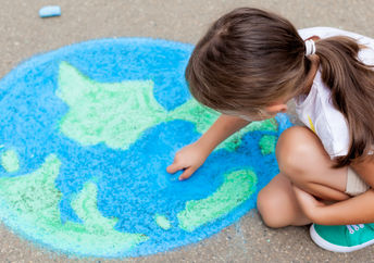 A girl drawing the earth.