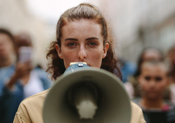 A woman protesting with a megaphone.