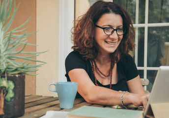 A woman studying at home .