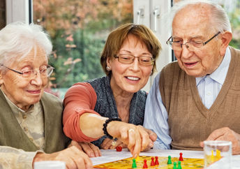 Parents and daughter playing a board game.