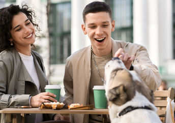 Couple enjoying eating out with their dog.
