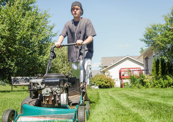 Teen cutting grass for people in need.