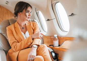 A relaxed woman flying in business class.