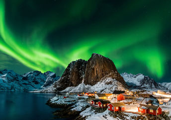 Aurora borealis over Hamnoy in Norway .